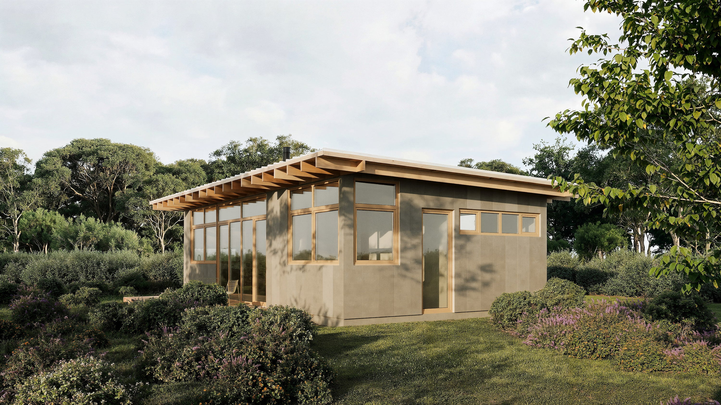 Modern wooden cabin in a natural setting with trees and greenery.