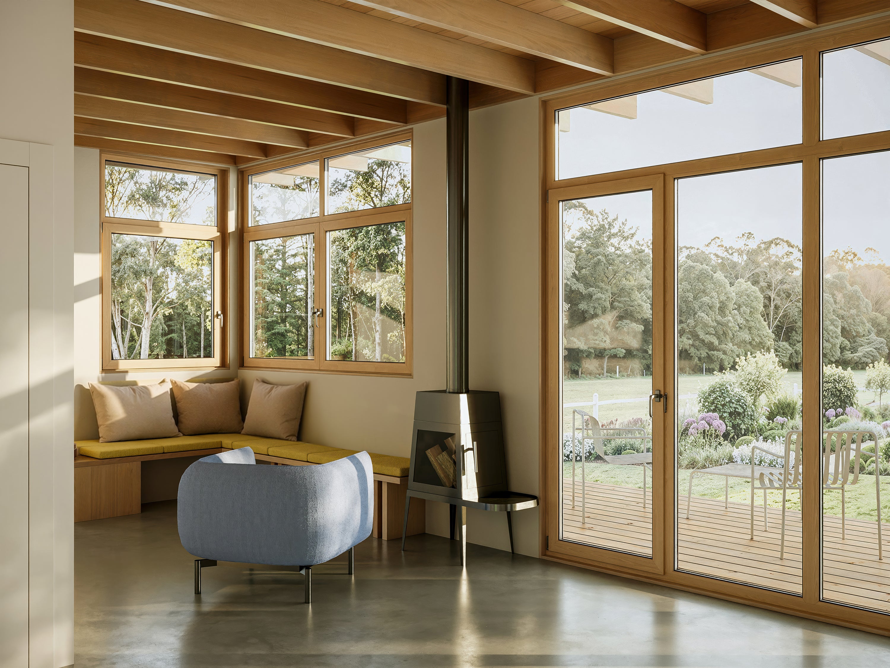 Modern living room with large windows and a view of a garden.